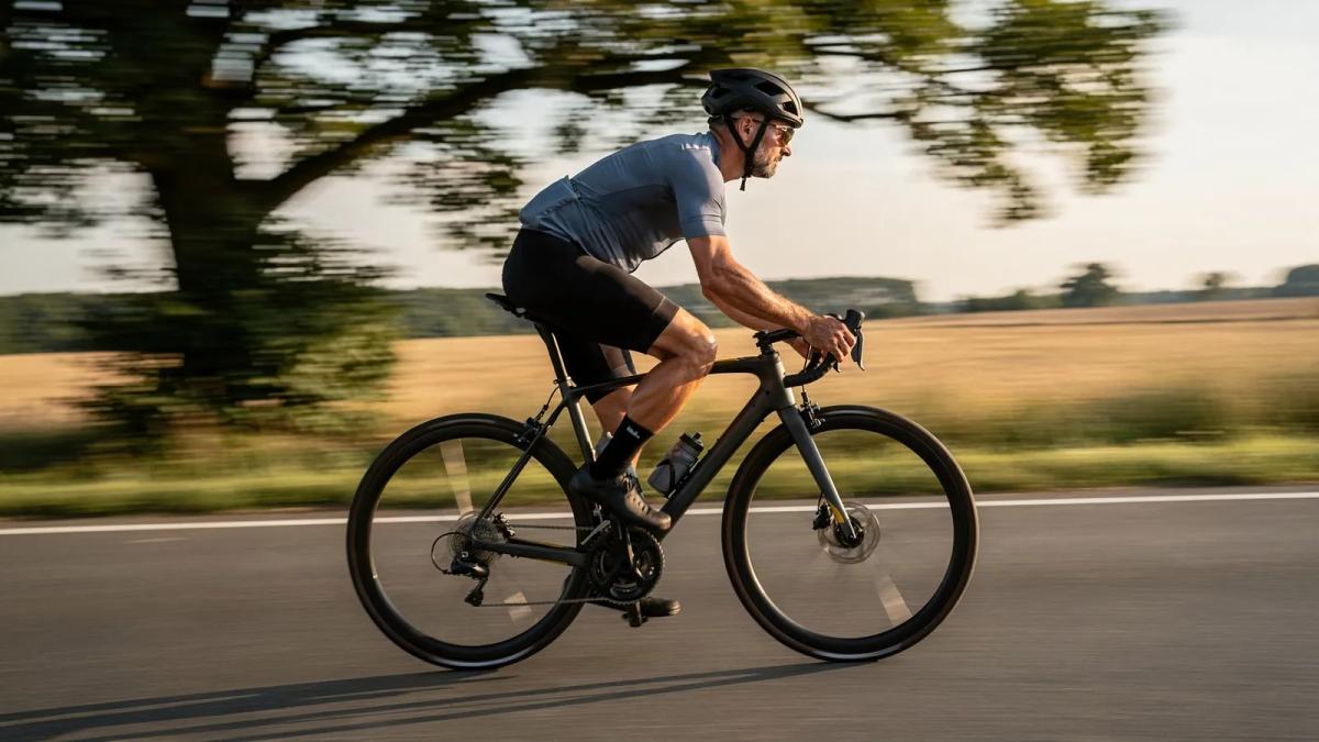 Filé d'un cycliste sur route : le coureur est net, le décor derrière lui est strié de flou
